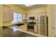Modern kitchen with stainless steel appliances, granite countertops, and warm yellow walls at 5250 S Rainbow Blvd # 2101, Las Vegas, NV 89118