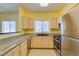 Kitchen featuring stainless steel appliances, light-colored cabinets, and granite countertops at 5250 S Rainbow Blvd # 2101, Las Vegas, NV 89118