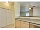 Kitchen area with stone countertops, stainless steel dishwasher, and access to the living room at 5250 S Rainbow Blvd # 2101, Las Vegas, NV 89118