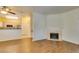 Spacious living room with wood floors, fireplace, and access to the kitchen area at 5250 S Rainbow Blvd # 2101, Las Vegas, NV 89118