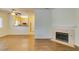 Inviting living room boasts a fireplace, wood floors, and an open view to the kitchen at 5250 S Rainbow Blvd # 2101, Las Vegas, NV 89118