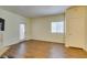 Living room showing hardwood floors, neutral paint, and a glass-paneled door to the outdoor space at 5250 S Rainbow Blvd # 2101, Las Vegas, NV 89118