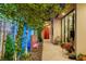 A beautifully landscaped backyard with a water feature and a walkway to seating, enhanced by ambient lighting at 527 Serenity Point Dr, Henderson, NV 89012