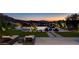 Backyard with a modern pool, lounge chairs, and well manicured lawn, ideal for relaxing in the evenings at 527 Serenity Point Dr, Henderson, NV 89012