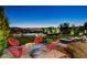 Outdoor space with chairs around a fire pit and a cityscape view at 527 Serenity Point Dr, Henderson, NV 89012