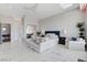 Expansive bedroom with white marble tile floors and a seating area, with great lighting at 527 Serenity Point Dr, Henderson, NV 89012