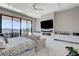Large primary bedroom featuring a fireplace, seating area, and a wall of sliding glass doors at 527 Serenity Point Dr, Henderson, NV 89012