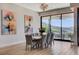 Bright dining room with modern chandelier, a table set with flowers, and sliding glass doors at 527 Serenity Point Dr, Henderson, NV 89012