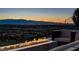 Outdoor patio features a linear fire feature, comfortable seating, and amazing city views at night at 527 Serenity Point Dr, Henderson, NV 89012