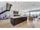 Open concept kitchen featuring a large center island with seating and a modern staircase in background at 527 Serenity Point Dr, Henderson, NV 89012