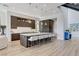 Modern kitchen with a large island, bar stools, pendant lighting, and sleek, dark wood cabinetry at 527 Serenity Point Dr, Henderson, NV 89012