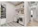 Functional laundry room with modern appliances, decorative floors and shelving at 527 Serenity Point Dr, Henderson, NV 89012