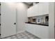 Well-lit laundry room with modern cabinets, a sink, and designer-tiled floors at 527 Serenity Point Dr, Henderson, NV 89012