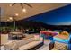 Expansive outdoor living area with plush seating, dining, a wet bar, and views of the surrounding landscape at 527 Serenity Point Dr, Henderson, NV 89012