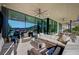 Spacious covered patio with modern furniture and expansive views through large glass doors at 527 Serenity Point Dr, Henderson, NV 89012