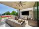 Relaxing outdoor covered patio with comfortable seating, tv, and grill at 527 Serenity Point Dr, Henderson, NV 89012