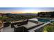 Backyard with a modern pool, comfortable seating, and fire feature, perfect for entertaining at sunset at 527 Serenity Point Dr, Henderson, NV 89012