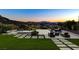 Relaxing backyard featuring a pool, lounge chairs, and lush landscaping with amazing sunset views at 527 Serenity Point Dr, Henderson, NV 89012