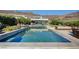Resort-style pool with comfortable lounge areas, seamlessly blending indoor/outdoor living at 527 Serenity Point Dr, Henderson, NV 89012
