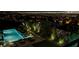 Beautifully landscaped backyard with a pool and loungers offers stunning views of city lights, a peaceful retreat at 527 Serenity Point Dr, Henderson, NV 89012