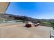 Spacious rooftop patio with stylish seating to enjoy views of the golf course and mountain range at 527 Serenity Point Dr, Henderson, NV 89012