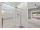 Bright bathroom with a glass enclosed shower and sliding door to a bedroom at 5338 Lignum Ave, Pahrump, NV 89061