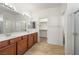 Bathroom boasts double sinks, walk-in closet, and wood-look tile floors at 5338 Lignum Ave, Pahrump, NV 89061
