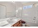 Bathroom with a single vanity, a soaking tub, a shower combo and wood-look floors at 5338 Lignum Ave, Pahrump, NV 89061