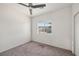 Cozy bedroom featuring carpet flooring, neutral walls, and a bright window providing ample natural light at 5338 Lignum Ave, Pahrump, NV 89061
