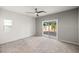 Spacious bedroom with a ceiling fan, carpeted floor, and sliding glass door to the backyard at 5338 Lignum Ave, Pahrump, NV 89061