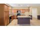 Bright kitchen with granite countertops, island, wood cabinets, and modern appliances at 5338 Lignum Ave, Pahrump, NV 89061