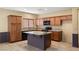 Kitchen featuring tile floors, granite countertops, and abundant cabinet space for storage and functionality at 5338 Lignum Ave, Pahrump, NV 89061