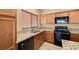 A kitchen featuring granite countertops, black appliances, and wooden cabinetry at 5338 Lignum Ave, Pahrump, NV 89061