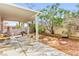 A backyard with a covered patio and desert landscaping perfect for relaxing and enjoying the outdoors at 5539 Foxtail Ridge St, North Las Vegas, NV 89031