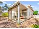 Covered patio with grill and swing with a view of the backyard at 5539 Foxtail Ridge St, North Las Vegas, NV 89031