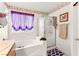 Bathroom featuring a combination tub/shower with tile surround and decorative wallpaper border at 5539 Foxtail Ridge St, North Las Vegas, NV 89031