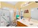 Bathroom with glass door shower, single sink vanity, and medicine cabinet at 5539 Foxtail Ridge St, North Las Vegas, NV 89031