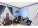 Bedroom featuring blue walls, carpeted floors, and small work desk at 5539 Foxtail Ridge St, North Las Vegas, NV 89031