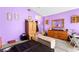Bedroom featuring purple walls, neutral carpet, and a large chest of drawers at 5539 Foxtail Ridge St, North Las Vegas, NV 89031