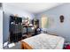 Bedroom featuring a wooden bed frame, window with blinds, and various furnishings at 5539 Foxtail Ridge St, North Las Vegas, NV 89031