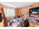 Small bedroom with wood floors, brass twin bed, and neutral trim at 5539 Foxtail Ridge St, North Las Vegas, NV 89031