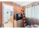 Cozy bedroom with ladder, wood floors, and en-suite bathroom at 5539 Foxtail Ridge St, North Las Vegas, NV 89031