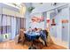 Charming dining room featuring a chandelier, hardwood floors, and large windows at 5539 Foxtail Ridge St, North Las Vegas, NV 89031