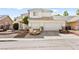 Two-story home featuring a three-car garage and low maintenance landscaping at 5539 Foxtail Ridge St, North Las Vegas, NV 89031
