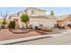 Exterior view of two-story house with a three-car garage and simple landscaping at 5539 Foxtail Ridge St, North Las Vegas, NV 89031