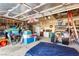 A cluttered garage featuring an array of stored items, shelving, and an open ceiling with visible supports at 5539 Foxtail Ridge St, North Las Vegas, NV 89031