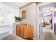 Upstairs hallway with wooden cabinet and view into a bedroom, showcasing the home's layout at 5539 Foxtail Ridge St, North Las Vegas, NV 89031