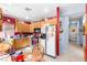 Functional kitchen with wood cabinets, stainless steel appliances, and red accent wall at 5539 Foxtail Ridge St, North Las Vegas, NV 89031