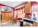 Cozy kitchen with red walls, breakfast table, and ample cabinet space at 5539 Foxtail Ridge St, North Las Vegas, NV 89031