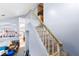 Carpeted staircase with wooden handrail and white banisters, leading to a bright upper level at 5539 Foxtail Ridge St, North Las Vegas, NV 89031